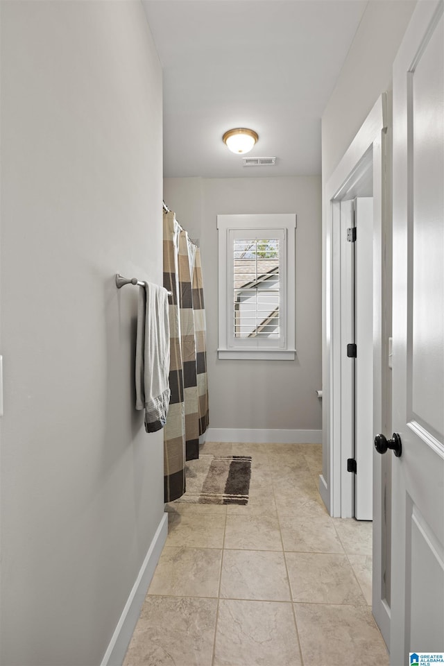 bathroom with tile patterned flooring, baseboards, and visible vents