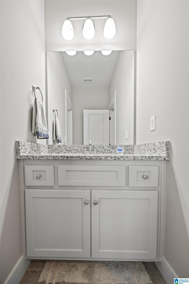 bathroom with visible vents, baseboards, and vanity