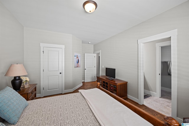 bedroom with wood finished floors and baseboards