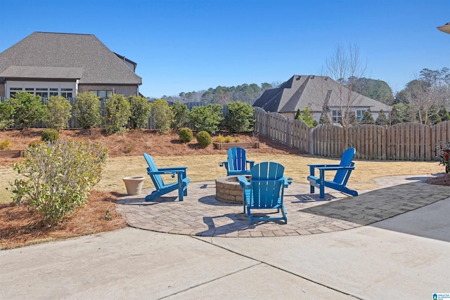 view of patio featuring a fire pit and fence