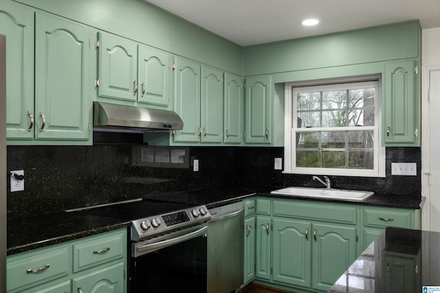 kitchen with under cabinet range hood, appliances with stainless steel finishes, green cabinets, and a sink