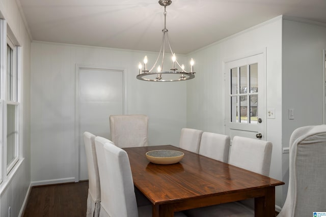 dining space with dark wood-style floors, baseboards, a chandelier, and ornamental molding