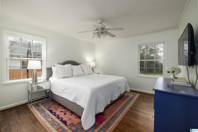 bedroom with a ceiling fan, dark wood-type flooring, and baseboards