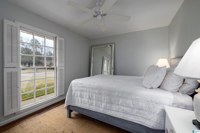 bedroom with visible vents, multiple windows, ceiling fan, and wood finished floors