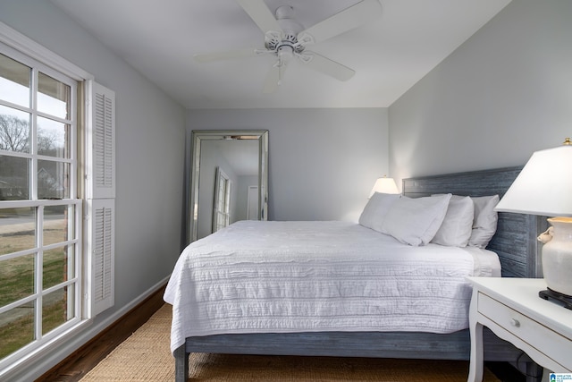 bedroom featuring baseboards, ceiling fan, and wood finished floors