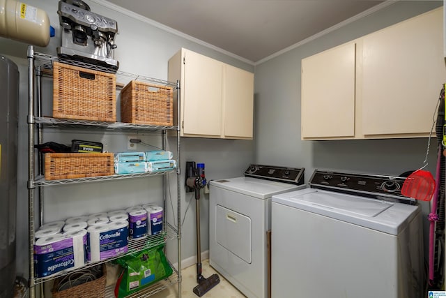 clothes washing area featuring washer and clothes dryer, cabinet space, and crown molding