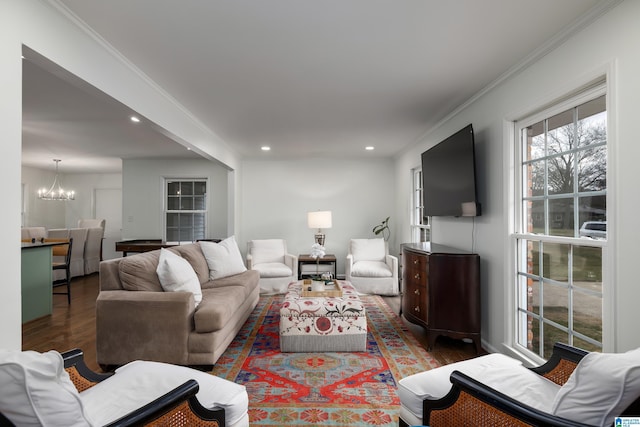 living room featuring recessed lighting, a chandelier, wood finished floors, and ornamental molding