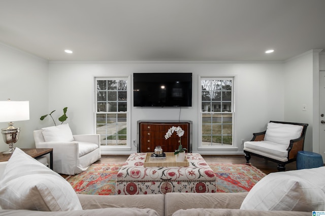 living area with recessed lighting, wood finished floors, and ornamental molding