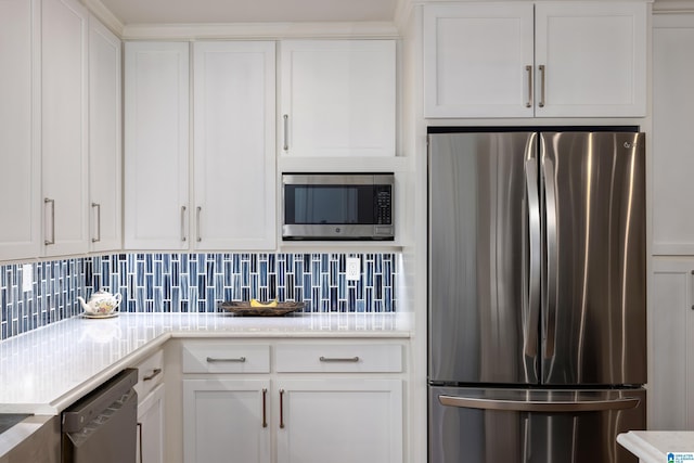 kitchen featuring backsplash, appliances with stainless steel finishes, white cabinets, and light countertops