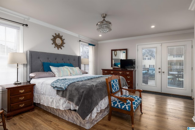 bedroom with crown molding, access to outside, and wood finished floors