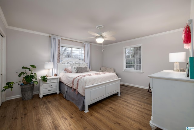 bedroom featuring a ceiling fan, crown molding, wood finished floors, and baseboards