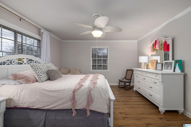 bedroom featuring dark wood-style floors, multiple windows, baseboards, and ornamental molding