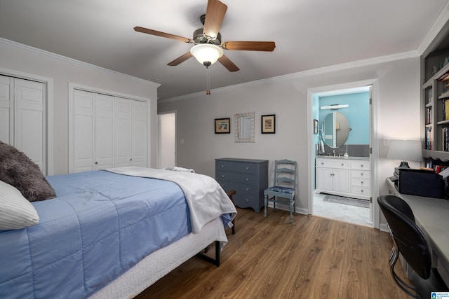 bedroom featuring multiple closets, ornamental molding, a ceiling fan, ensuite bathroom, and wood finished floors