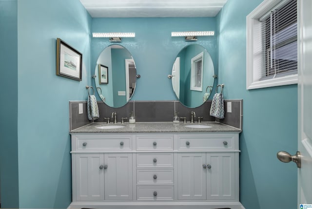 full bathroom featuring tasteful backsplash, double vanity, and a sink