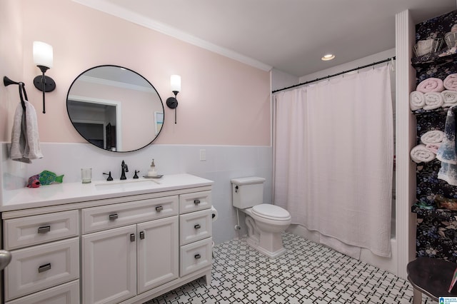 bathroom featuring toilet, tile walls, ornamental molding, and vanity