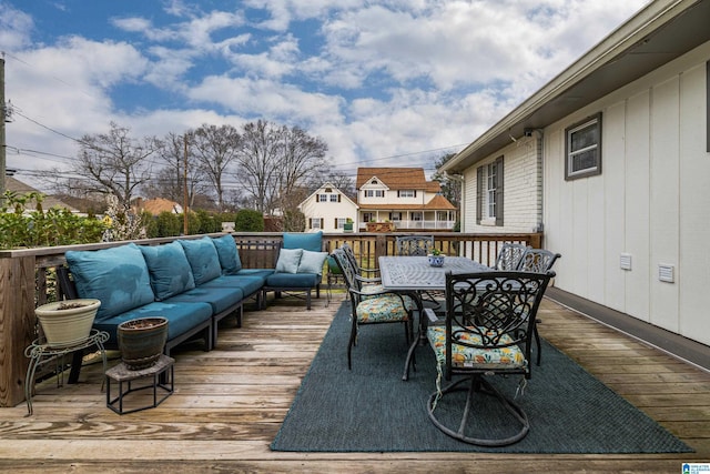 wooden deck featuring outdoor dining space and an outdoor hangout area