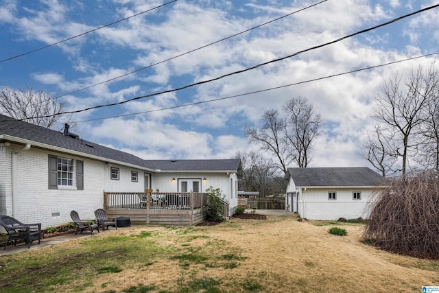 back of property with brick siding, a yard, a patio, and a deck