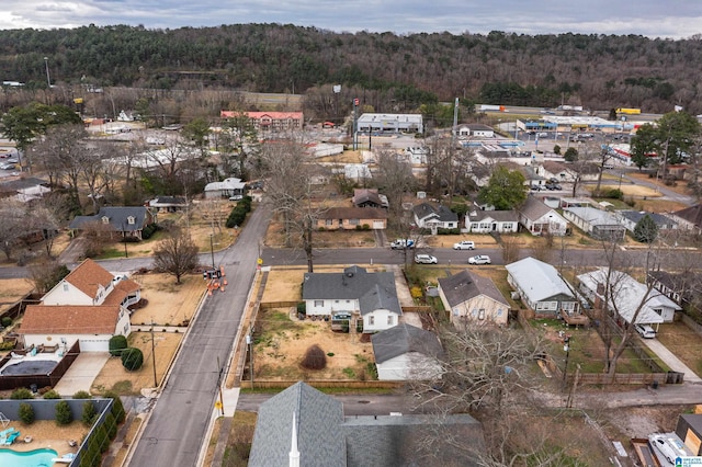 drone / aerial view featuring a residential view and a wooded view