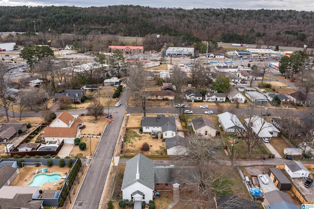 birds eye view of property with a forest view and a residential view