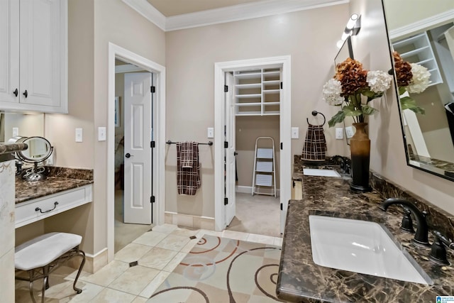 full bath with a sink, ornamental molding, double vanity, and tile patterned flooring