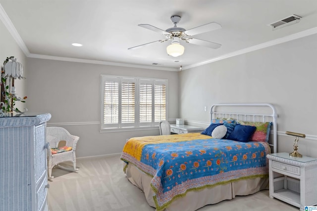 carpeted bedroom featuring visible vents, a ceiling fan, crown molding, and baseboards