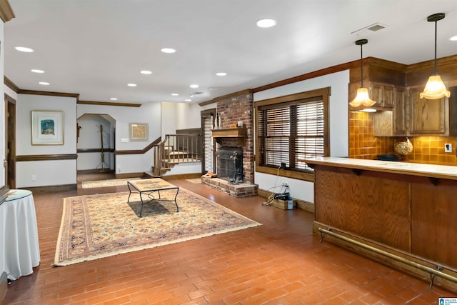 living area featuring brick floor, recessed lighting, baseboards, and ornamental molding