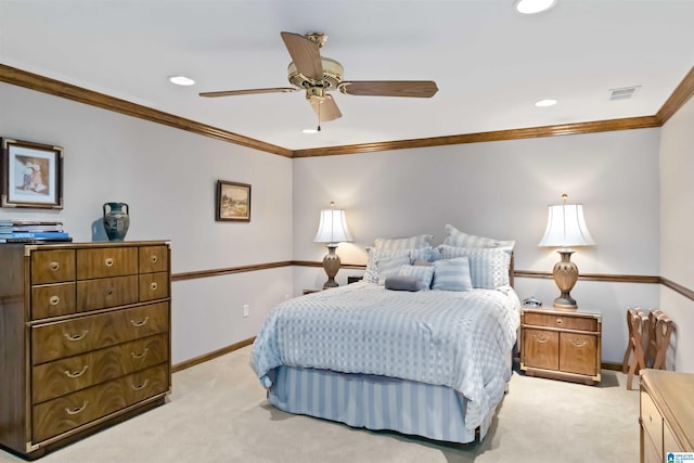 bedroom with visible vents, light colored carpet, baseboards, and ornamental molding