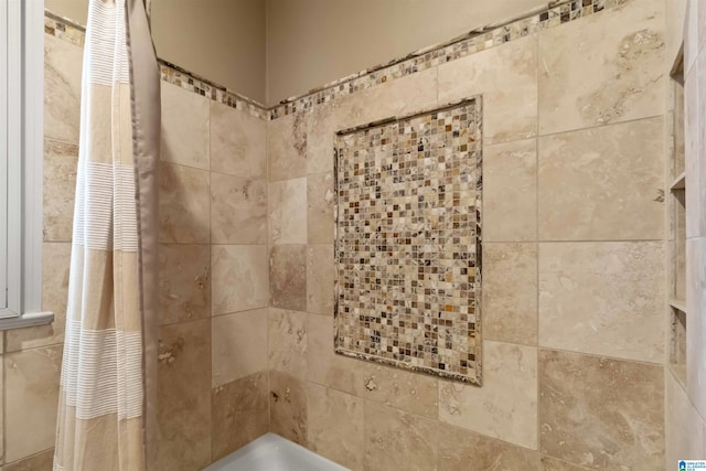 interior details featuring a tile shower