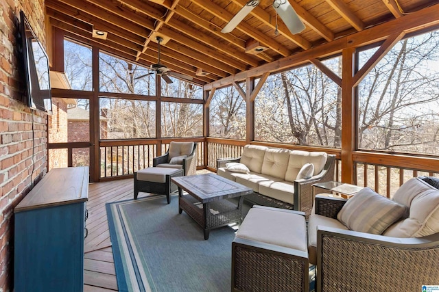 sunroom featuring a ceiling fan