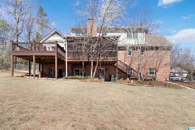 back of house with stairway, a lawn, a wooden deck, and brick siding