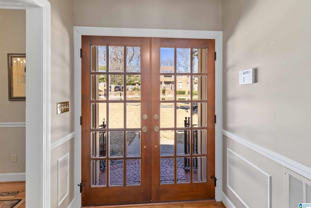 entryway featuring a wealth of natural light, french doors, and visible vents