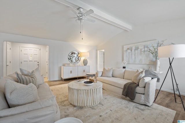 living room with vaulted ceiling with beams, light wood finished floors, baseboards, and a ceiling fan