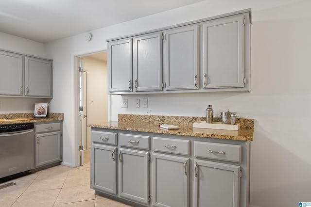 kitchen featuring light tile patterned floors, gray cabinets, visible vents, stainless steel dishwasher, and light stone countertops