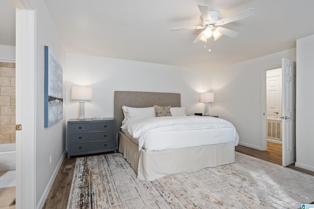 bedroom featuring visible vents, ceiling fan, baseboards, and wood finished floors