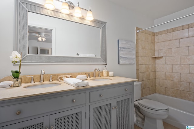 full bathroom with toilet, shower / tub combination, double vanity, and a sink