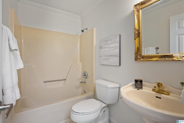 bathroom featuring bathing tub / shower combination, a sink, toilet, and crown molding