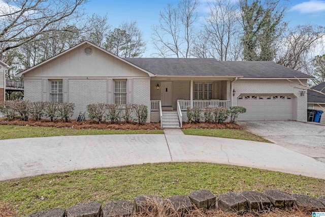 ranch-style house with covered porch, driveway, brick siding, and a garage