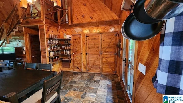 interior space featuring wood walls and stone finish floor