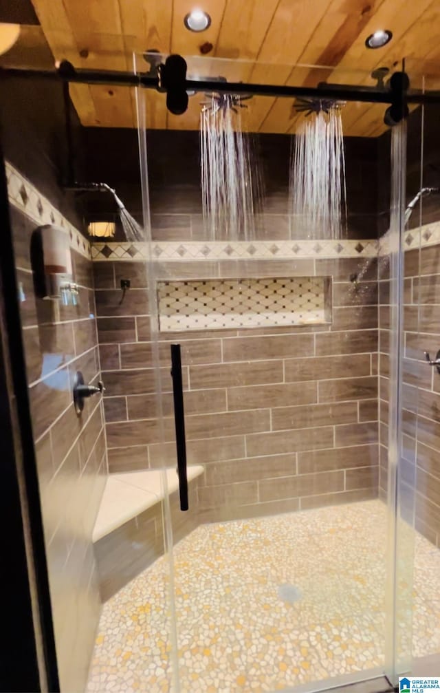 full bathroom with wood ceiling and a shower stall