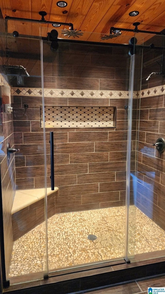 bathroom featuring wooden ceiling and a shower stall