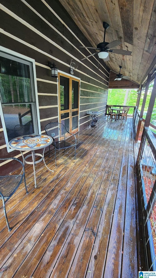 wooden terrace featuring ceiling fan