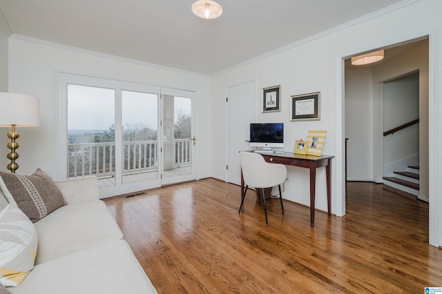 home office with ornamental molding, visible vents, and wood finished floors