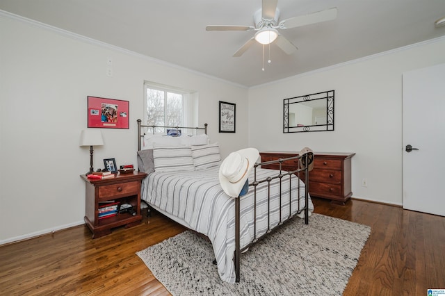 bedroom with baseboards, wood finished floors, a ceiling fan, and crown molding