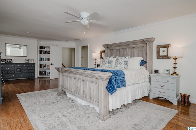 bedroom featuring wood finished floors, a ceiling fan, and crown molding