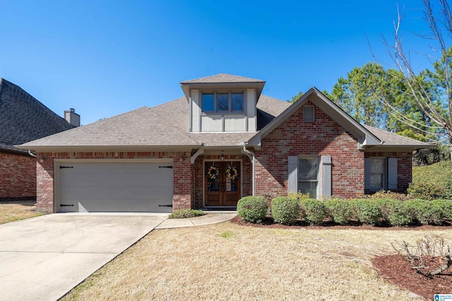 view of front of property with french doors, brick siding, roof with shingles, concrete driveway, and a garage