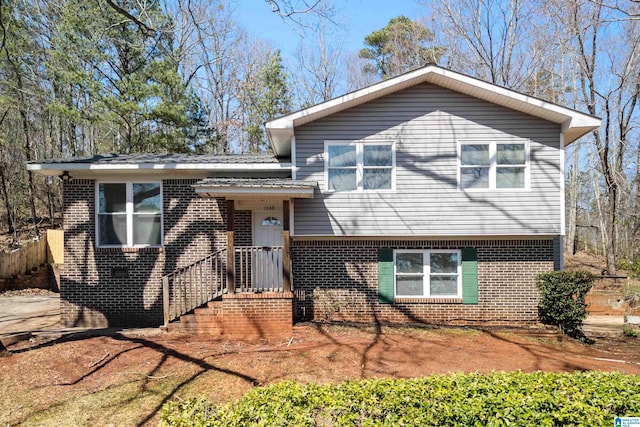 split level home featuring brick siding