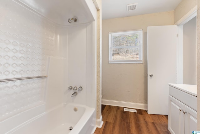 full bathroom featuring baseboards, visible vents, bathing tub / shower combination, wood finished floors, and vanity