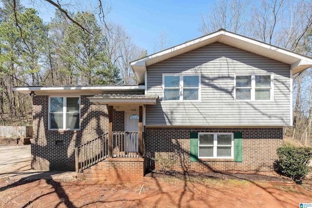 split level home with brick siding