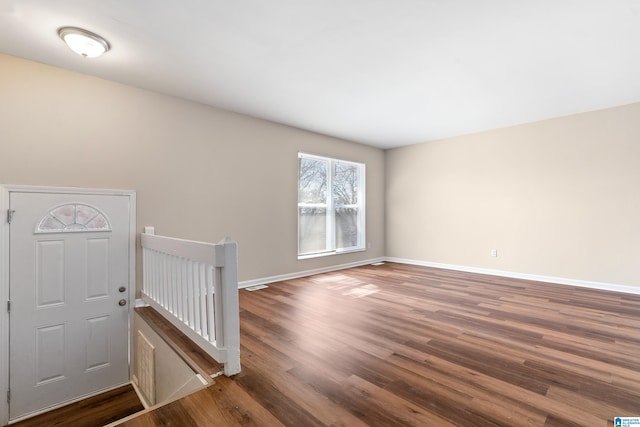 foyer entrance with wood finished floors and baseboards