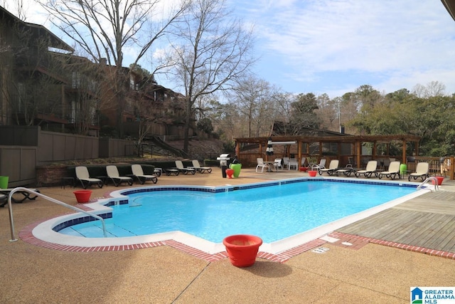 pool featuring a pergola, a patio, and fence